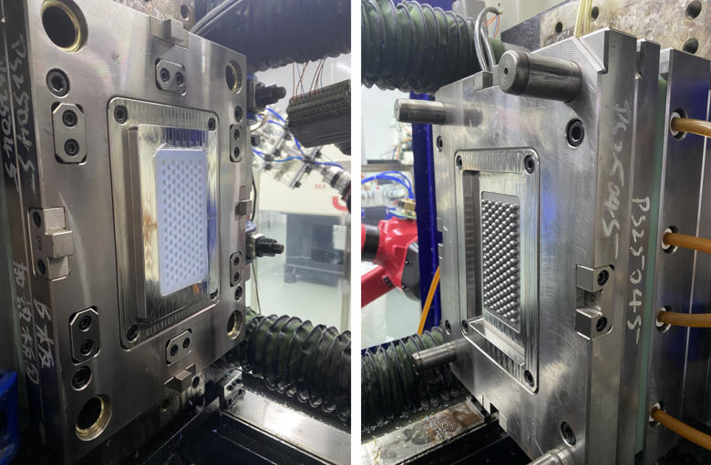 High-precision multi cavity injection moulding tool designed and manufactured by Packson, shown inside the machine for high-volume production of intricate perforated components.